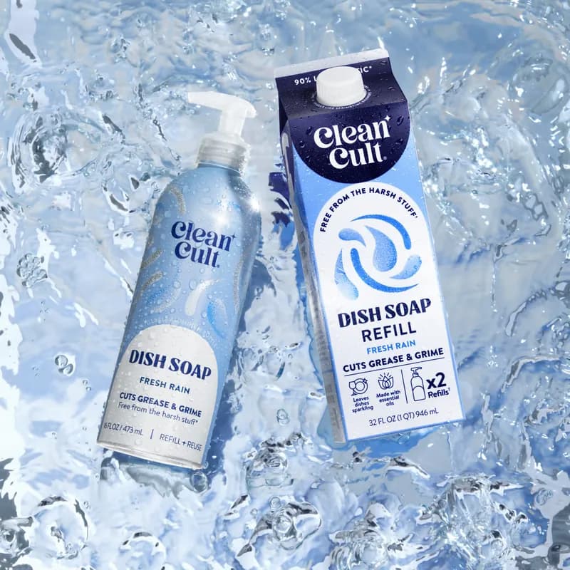 A bottle and a refill carton of dish soap in a splash of clear water