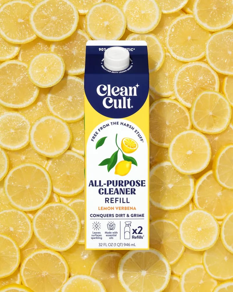 A Lemon Verbena all-purpose cleaner refill on a bed of lemon slices