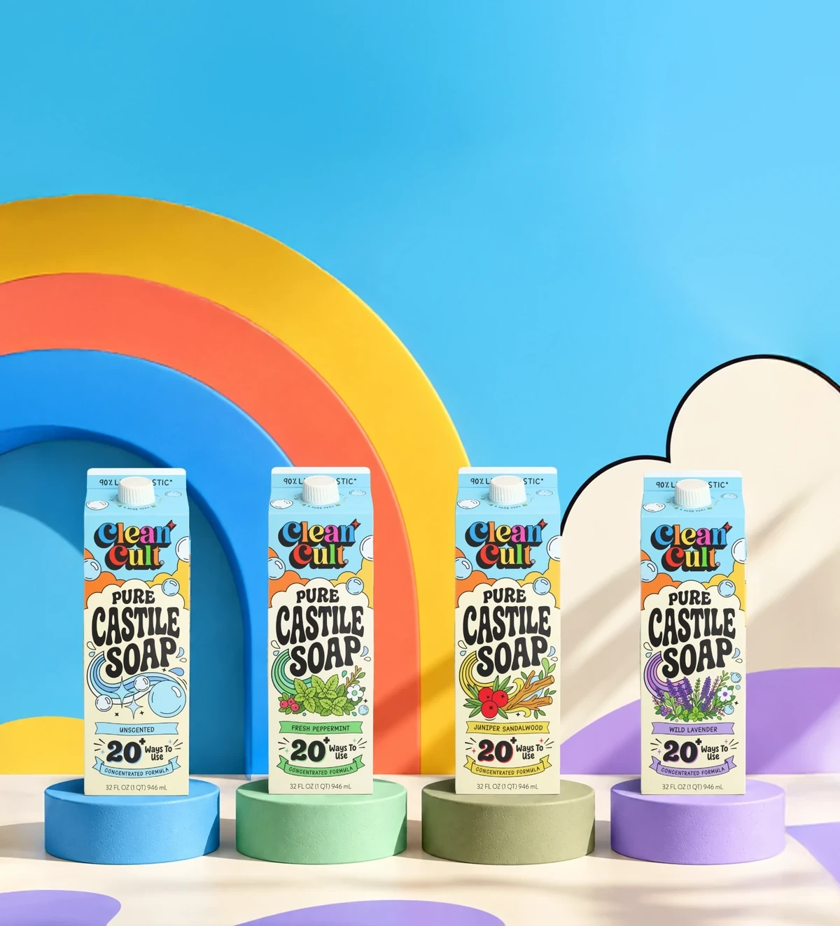 All four Castile Soap scents on colorful pedestals in front of a rainbow arch